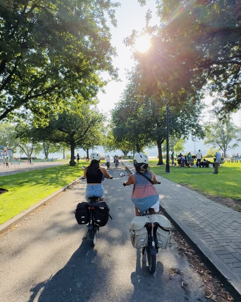 Two girls head out towards Okanagan Lake in Kelowna, British Columbia for an E-Bike Wine Tasting Tour