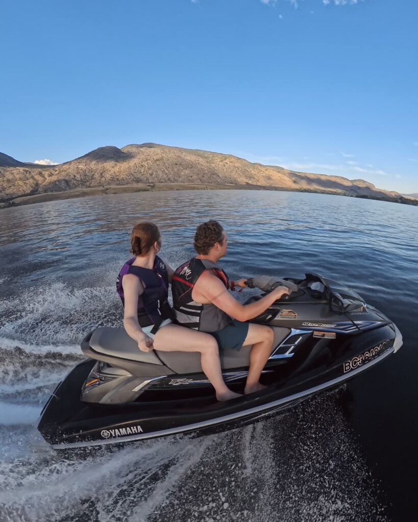 A man and woman rip though Osoyoos lake on a Seadoo Jetski in British Columbia