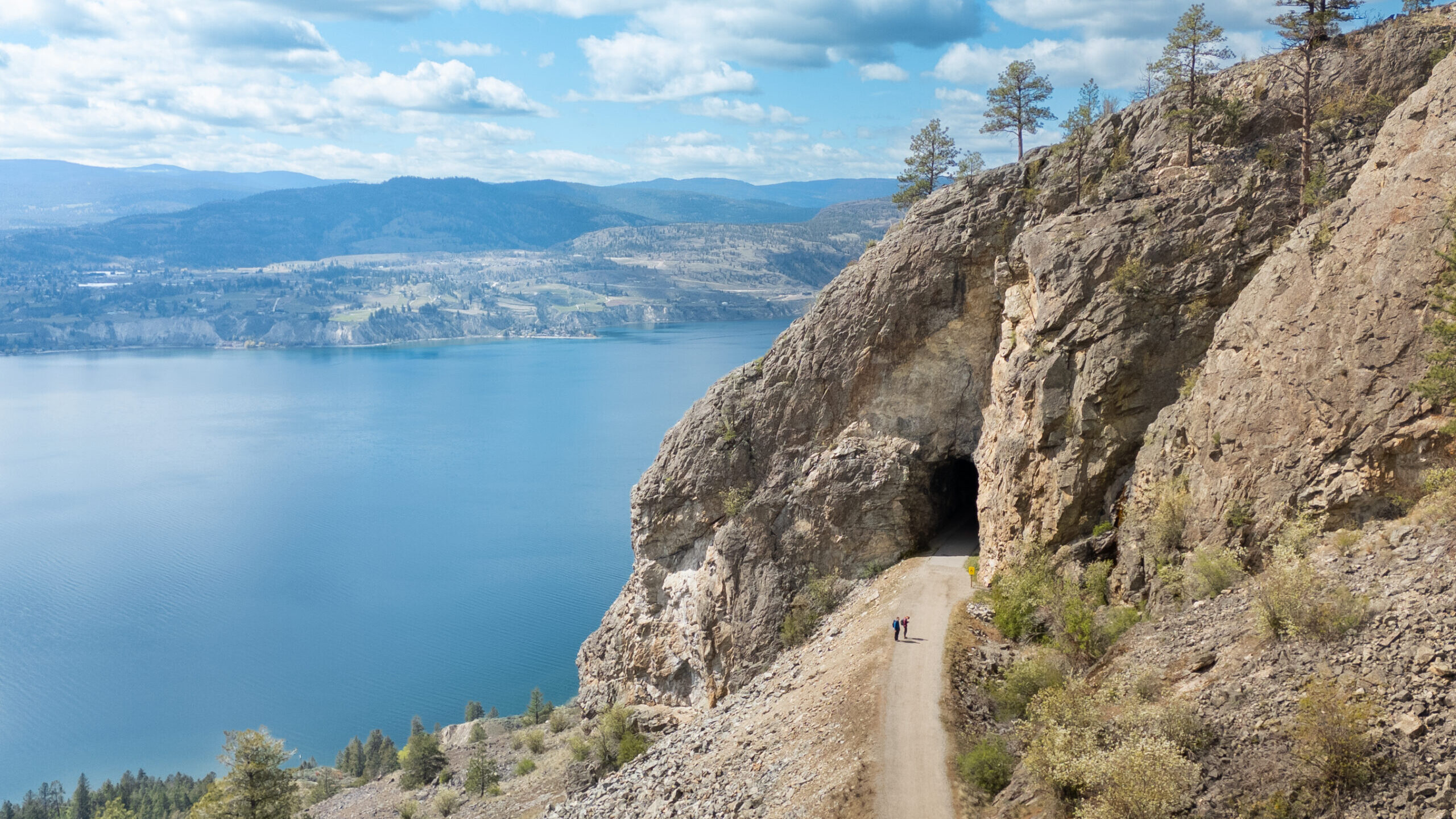 The Little Tunnel on the KVR Trail in Naramata British Columbia. Okanagan lake is in the background